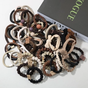 Detail of high-elasticity hair ties set with beads and handmade leather labels