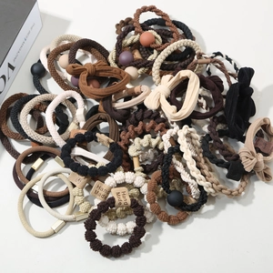 Detailed close-up of premium handmade hair ties set in earthy tones with bead charms
