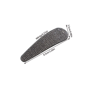 Detail view of oval rhinestone hair clip with dimensions 8.3cm by 2.5cm in gunmetal gray