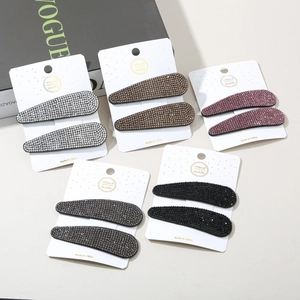 Detailed close-up of rhinestone teardrop hair clips set in multiple elegant colors