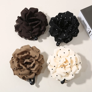 Set of four 3D polka dot flower hair claws in black, brown, camel, and beige colors