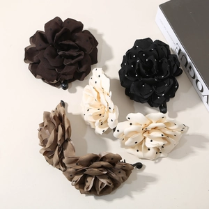 Elegant floral banana hair clips with polka dot patterns in multiple colors and textures