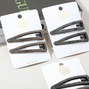 Sparkling rhinestone hair clip set with triangular patterns on elegant display card