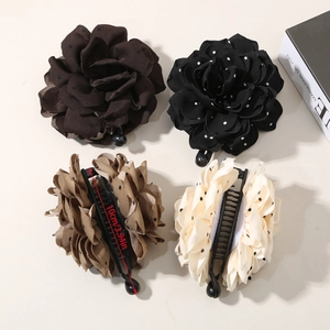 Detail view of 10cm floral polka dot banana clips in coffee, black, khaki and white