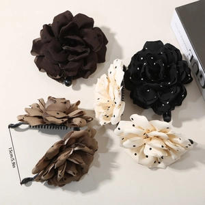 Detail view of 15cm large fabric rose hair clips with polka dots and banana clip design
