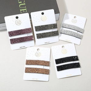 Detail view of five colors of handmade rhinestone hair clips on display cards
