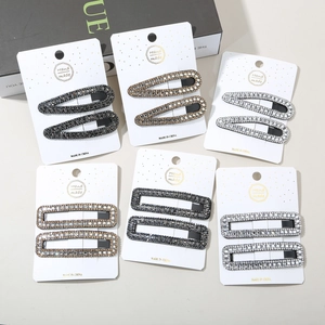 Detailed set of twelve rhinestone hair clips in drop and rectangular shapes on cards