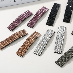 Macro shot of rectangular hair clips with multi-color rhinestones in various colors