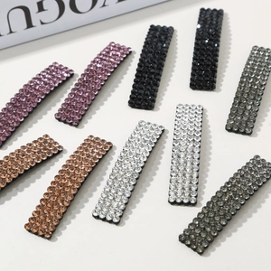 Detail of square rhinestone hair clip set in pink, black, champagne, silver and gray