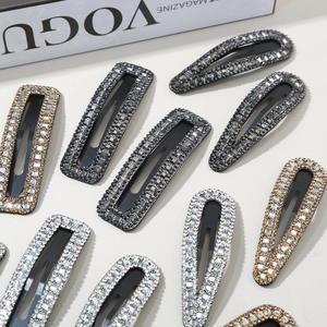 Detail of rhinestone hair clips set featuring crystal embellishments and metal base