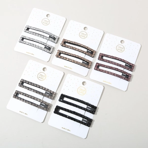 Detailed view of handmade rectangular hair clips set with shimmering rhinestones in 5 colors