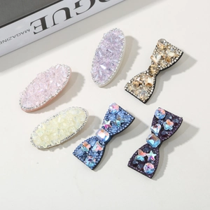 Detailed view of handmade hair clips featuring colorful rhinestones and crystal embellishments