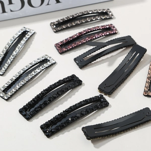 Detail of sparkling rhinestone rectangular hair clips with various colors and metal base