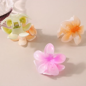 Three gradient floral hair claws in green, orange, and purple for stylish hair styling