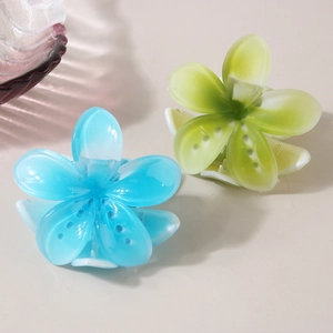 Frangipani hair claws in blue and yellow gradients, floral resin shark clips for women