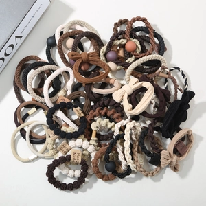 Detail of high-quality hair scrunchie set with woven textures and beads in earth tones