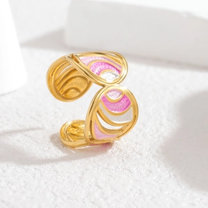 Detailed close-up of golden adjustable butterfly ring with pink and white enamel inlay
