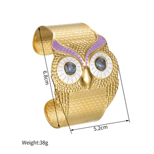 Wide gold-tone owl cuff bracelet with purple enamel eyes and 6.8cm height dimensions