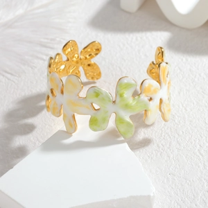 Detail of floral enamel open cuff bracelet with colorful gold-plated metal flower design