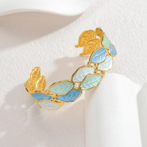 Detail showing colorful leaf enamel on adjustable gold-plated metal bangle bracelet