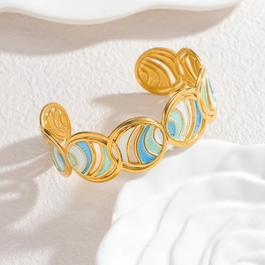 Elegant gold-tone enamel geometric open bangle with blue and mint sea-scale patterns