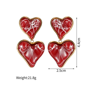 Close-up detail of double layered red heart resin earrings with size 4.4cm by 2.5cm labels