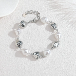 Detailed view of baroque pearl and irregular silver metal bead bracelet with lobster clasp