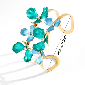 Detail of teal enamel flower bracelet with gold finish showing the 6cm diameter size