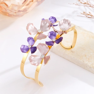 Detail of gold enamel floral bangle with lavender petals and centered crystal zircons