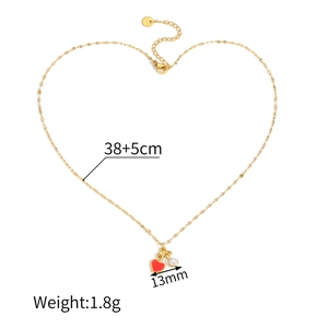 Detail showing red heart and pearl pendant on gold plated stainless steel chain