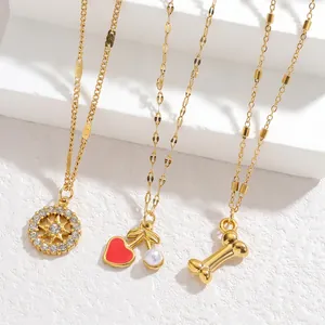 Golden necklaces set with starburst, cherry, and bone pendants in minimalist style