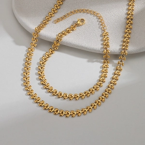 Golden wheat-shaped stainless steel necklace with textured V-shaped leaf links and lobster clasp