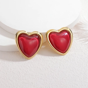 Elegant vintage heart stud earrings with red resin and a textured gold metal frame