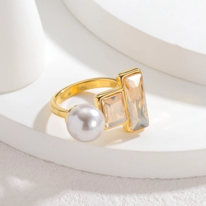Vintage gold ring with round white pearl and champagne zircon stones on white background