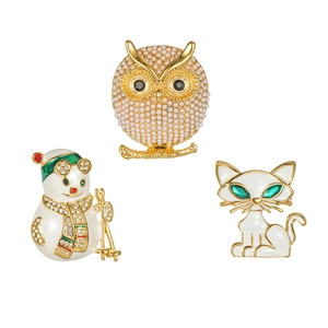 Lot de trois broches avec chouette perlée, bonhomme de neige et chat blanc en émail