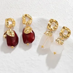 Golden irregular hammered D-shape earrings with deep red and white resin charms