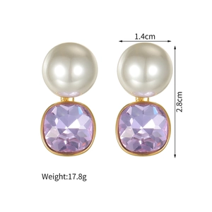 Detail view of pearl and purple zircon earrings with dimensions 1.4cm by 2.8cm