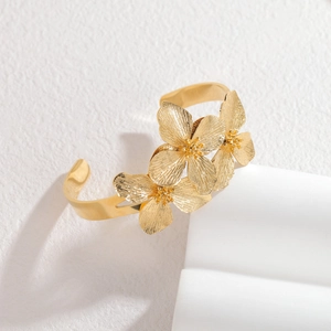 Retro stainless steel wide open cuff bracelet with three dimensional golden flower petals