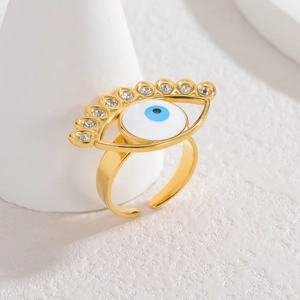 Adjustable golden evil eye ring with blue stones and zircon inlay on white stand
