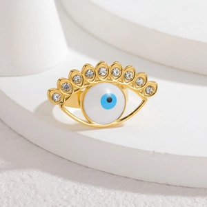 Golden evil eye open ring with blue enamel and sparkling crystal eyelashes on a stone