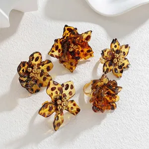Elegant amber leopard print resin flower open rings with golden core on stone background
