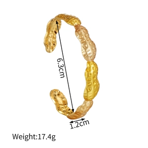 Detail view of the gold peanut textured cuff bangle with 6.3cm diameter and 1.2cm width