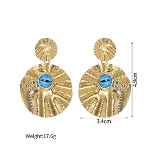 Detailed view of irregular textured gold earrings with turquoise inlay and size markings