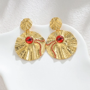 Gold round earrings with irregular radial texture and red cat-eye stone inlay