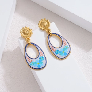 Detail of vintage floral earrings with sunflower stud and blue painted teardrop pendant