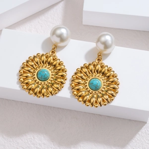 Detail of vintage sunflower earrings with white pearl and turquoise stone inlay