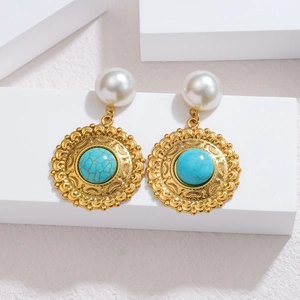 Detailed close-up of retro turquoise and pearl drop earrings on white geometric stands