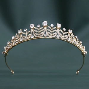 Macro shot of gold bridal crown featuring intricate leaf patterns and sparkling 3A zircons