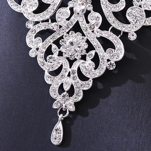 Vue macro de la parure de mariée argentée avec cristaux floraux et pendentif en goutte