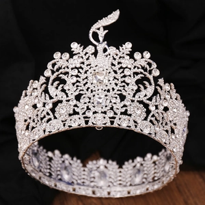 Macro detail of silver baroque crown with crystal swan motifs and shimmering rhinestones